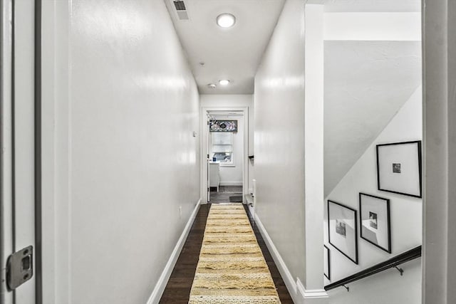 corridor featuring dark wood-type flooring