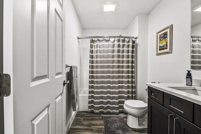 full bathroom featuring toilet, vanity, shower / bathtub combination with curtain, and hardwood / wood-style flooring