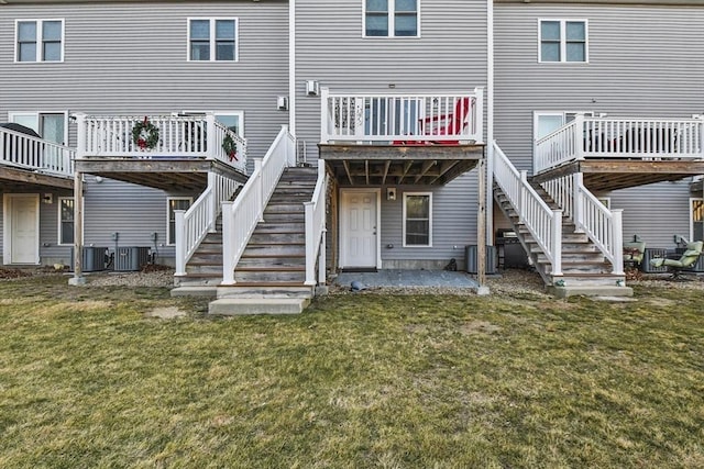 rear view of property featuring a yard and cooling unit