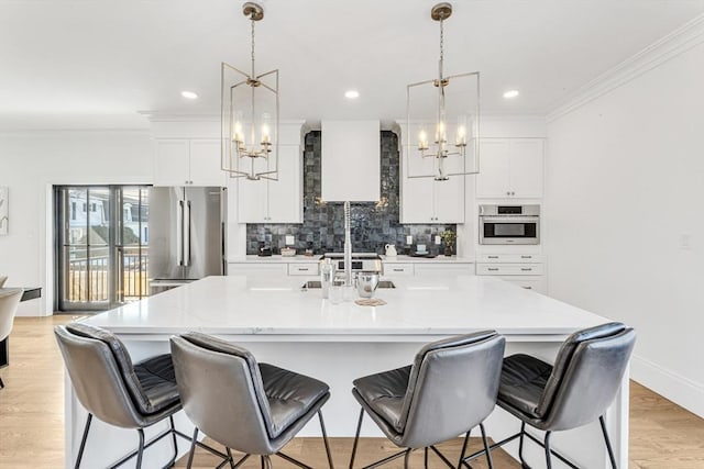 349 Baker St, Boston, MA 02132 - kitchen featuring a chandelier, stainless steel appliances, backsplash, white cabinets, and ornamental molding