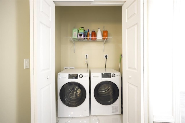 clothes washing area featuring washing machine and dryer