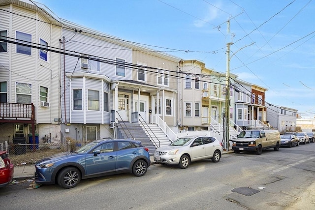 townhome / multi-family property featuring a residential view and cooling unit