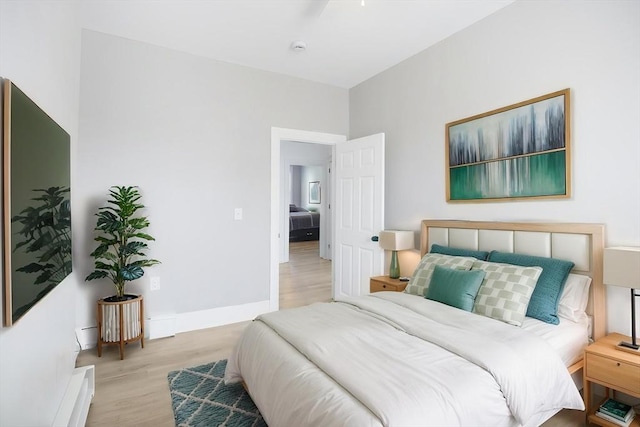 bedroom featuring wood finished floors and baseboards