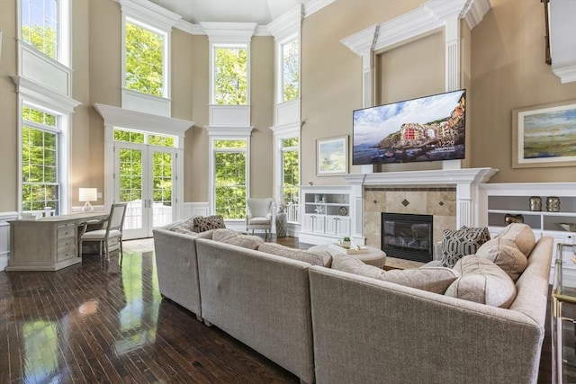 3 Newton Ln, Medway, MA 02053 - living area with a towering ceiling, a fireplace, french doors, dark wood finished floors, and plenty of natural light