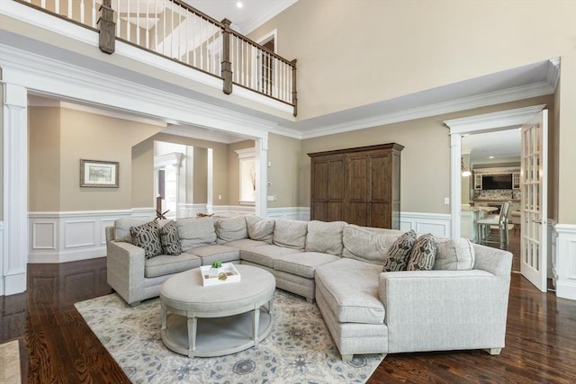 3 Newton Ln, Medway, MA 02053 - living room with decorative columns, a decorative wall, dark wood finished floors, crown molding, and wainscoting