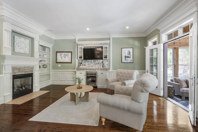 3 Newton Ln, Medway, MA 02053 - living room with beverage cooler, a fireplace, built in features, dark wood-style flooring, and ornamental molding