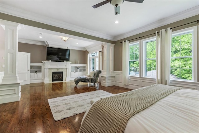 3 Newton Ln, Medway, MA 02053 - bedroom with decorative columns, wood finished floors, a decorative wall, a fireplace with flush hearth, and wainscoting