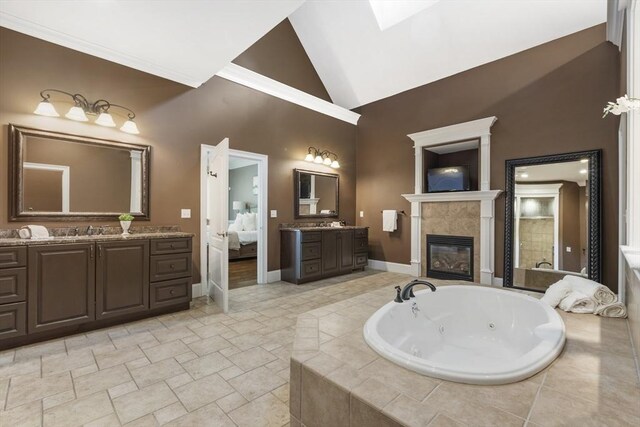 3 Newton Ln, Medway, MA 02053 - full bathroom with a tile fireplace, a tub with jets, baseboards, two vanities, and high vaulted ceiling