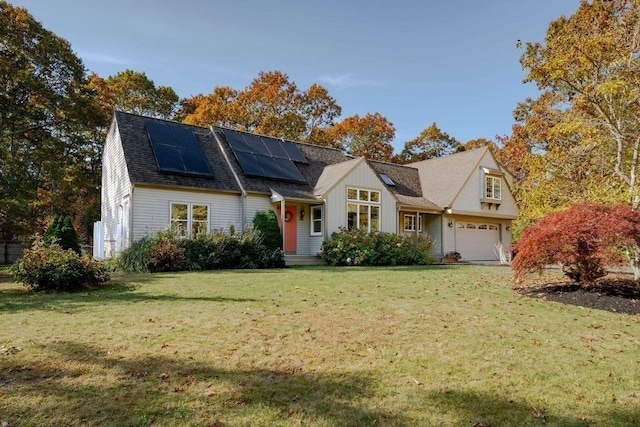 view of front facade featuring a garage, a front lawn, and solar panels