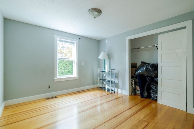 bedroom with hardwood / wood-style flooring and a closet