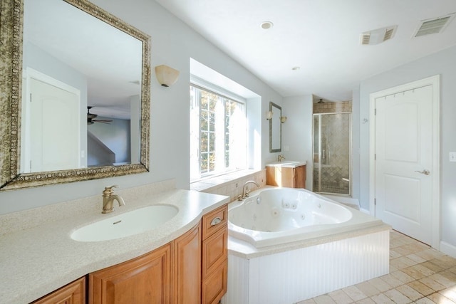 bathroom featuring tile patterned flooring, vanity, and separate shower and tub