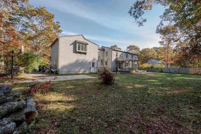 rear view of property with a yard