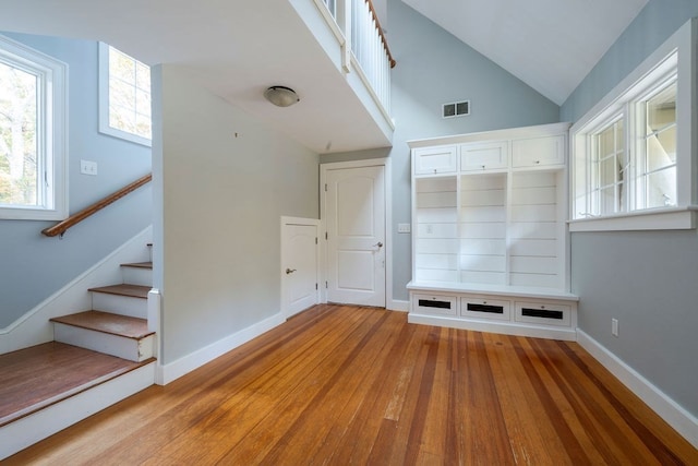 mudroom featuring vaulted ceiling and light hardwood / wood-style floors