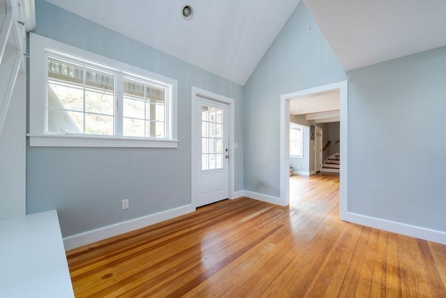 entrance foyer featuring vaulted ceiling and light hardwood / wood-style floors