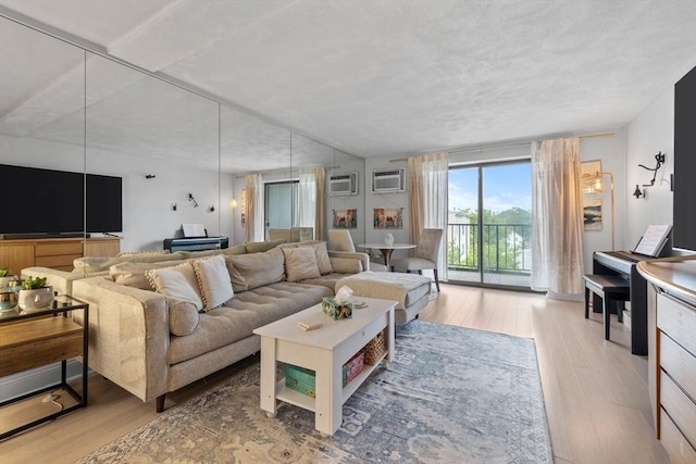 12 Pond Ln Unit 65, Arlington, MA 02474 - living room with wood finished floors and an AC wall unit