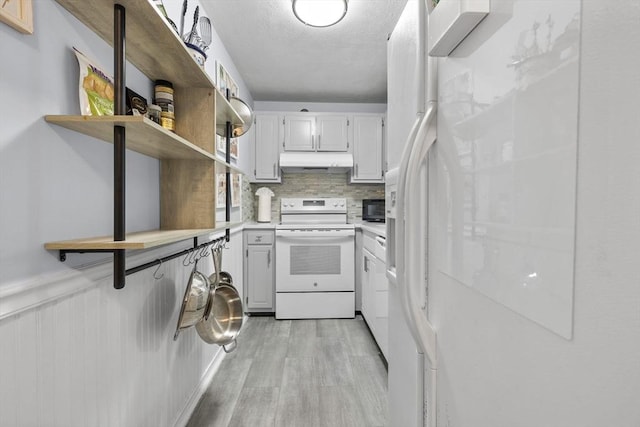 12 Pond Ln Unit 65, Arlington, MA 02474 - kitchen featuring white appliances, under cabinet range hood, open shelves, light wood-style floors, and light countertops