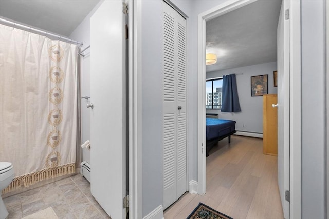 12 Pond Ln Unit 65, Arlington, MA 02474 - bathroom featuring a baseboard heating unit, a closet, toilet, and wood finished floors