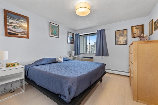 12 Pond Ln Unit 65, Arlington, MA 02474 - bedroom with baseboard heating and light wood-style floors