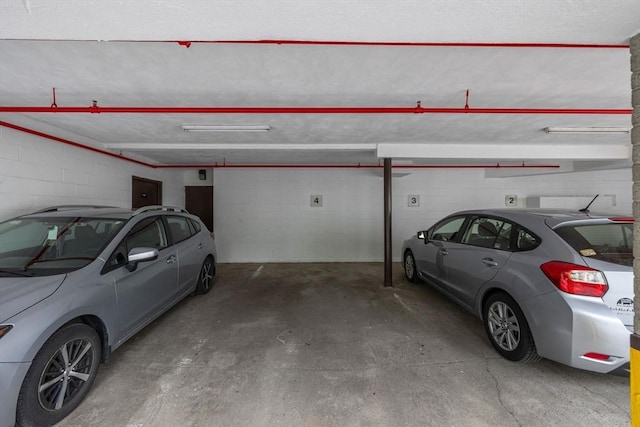 12 Pond Ln Unit 65, Arlington, MA 02474 - parking deck featuring electric panel and concrete block wall