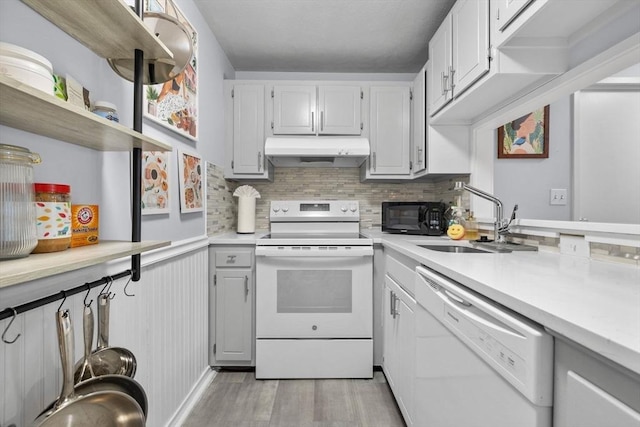 12 Pond Ln Unit 65, Arlington, MA 02474 - kitchen with white appliances, under cabinet range hood, light wood finished floors, a sink, and open shelves