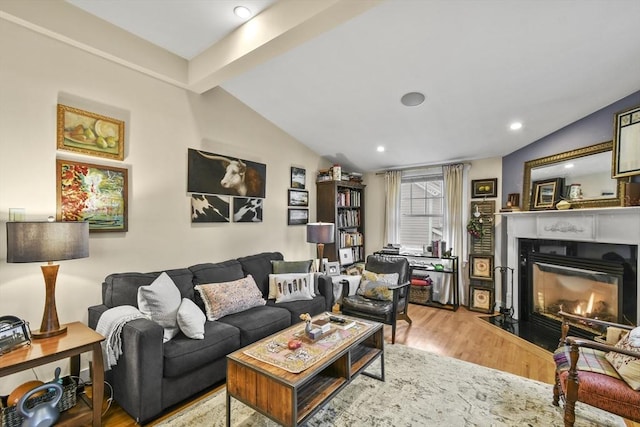 living area featuring a fireplace with flush hearth, lofted ceiling with beams, light wood-style floors, and recessed lighting