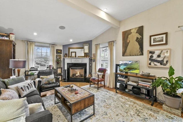 living room with a fireplace with flush hearth, vaulted ceiling with beams, wood finished floors, and recessed lighting