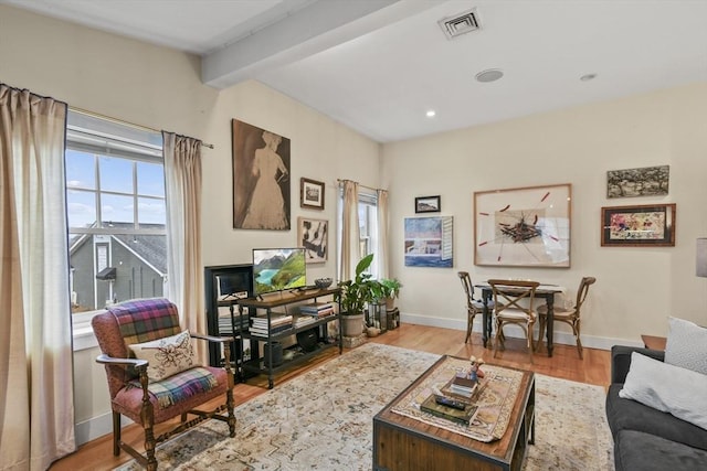 living area featuring recessed lighting, baseboards, beamed ceiling, visible vents, and wood finished floors