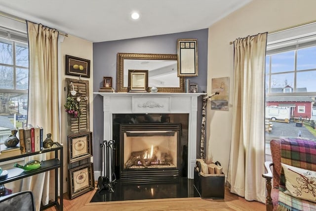 interior space featuring a fireplace with flush hearth and a wealth of natural light