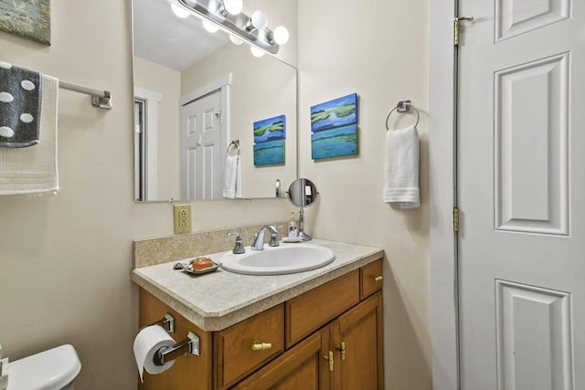 half bathroom featuring toilet and vanity