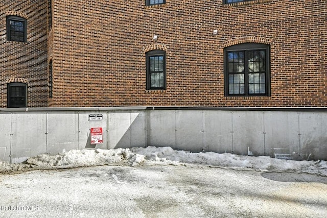 view of side of property featuring brick siding