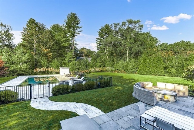 view of property's community with a pool, a fire pit, a patio area, and a lawn