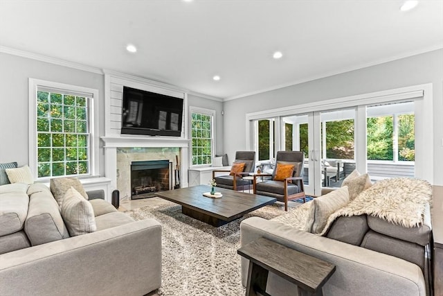 living room featuring crown molding, a high end fireplace, and french doors