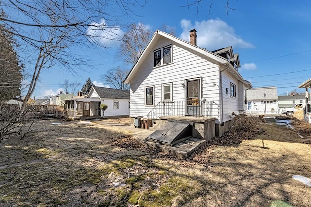 back of property featuring a chimney