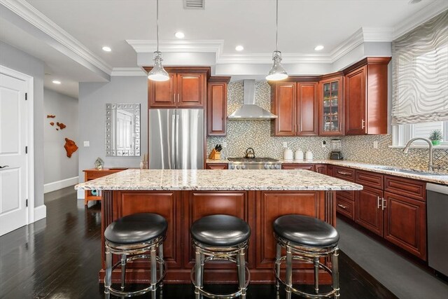 615 E 6th St Unit 6, Boston, MA 02127 - kitchen featuring appliances with stainless steel finishes, wall chimney range hood, a sink, a center island, and baseboards