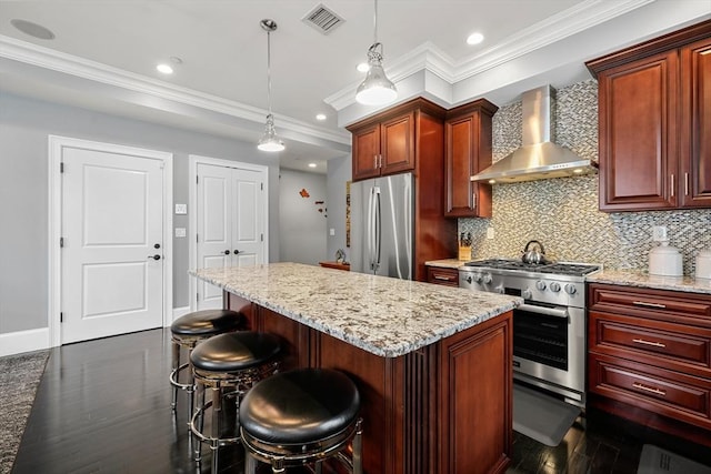615 E 6th St Unit 6, Boston, MA 02127 - kitchen featuring wall chimney exhaust hood, stainless steel appliances, ornamental molding, tasteful backsplash, and dark wood-style flooring