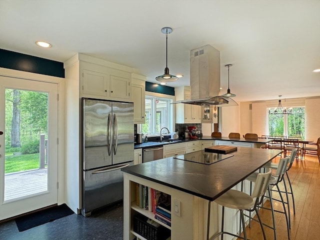 187 Plain Rd, Greenfield, MA 01301 - kitchen featuring appliances with stainless steel finishes, dark countertops, island exhaust hood, a sink, and a peninsula