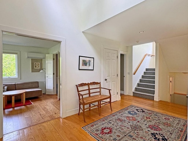 187 Plain Rd, Greenfield, MA 01301 - sitting room featuring a wall unit AC, light wood-type flooring, and stairs