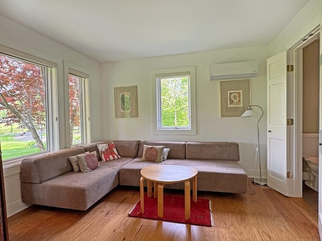187 Plain Rd, Greenfield, MA 01301 - living area featuring a wall mounted AC, healthy amount of natural light, and light wood-style floors