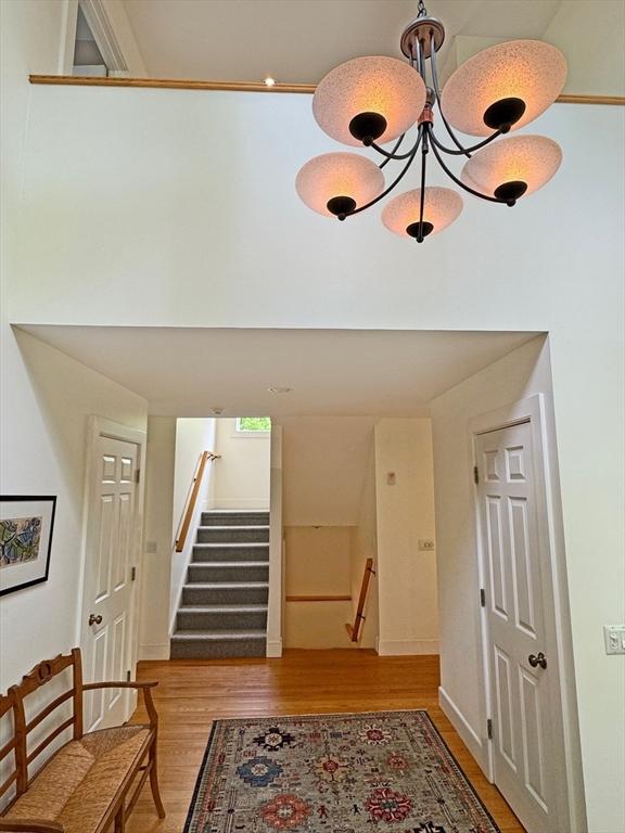 187 Plain Rd, Greenfield, MA 01301 - foyer entrance with light wood-type flooring, stairs, and a chandelier