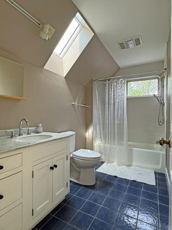 187 Plain Rd, Greenfield, MA 01301 - bathroom with a skylight, tile patterned flooring, toilet, shower / bath combo, and vanity