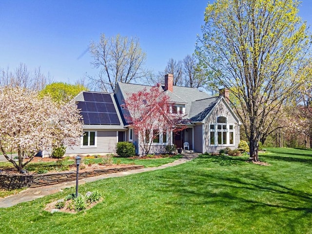 187 Plain Rd, Greenfield, MA 01301 - view of front of home with solar panels, a front yard, and a chimney