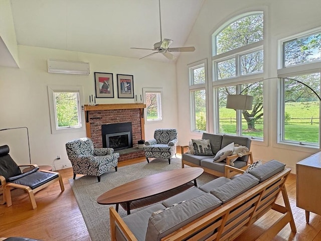 187 Plain Rd, Greenfield, MA 01301 - living room featuring plenty of natural light, a wall mounted AC, light wood-type flooring, a fireplace, and high vaulted ceiling