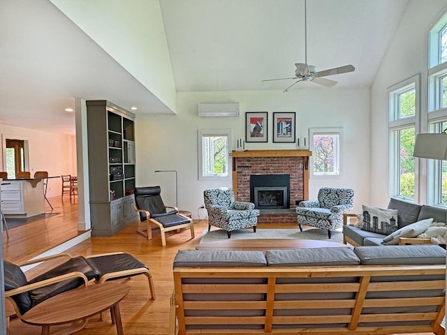 187 Plain Rd, Greenfield, MA 01301 - living area with an AC wall unit, high vaulted ceiling, light wood-type flooring, a ceiling fan, and a fireplace