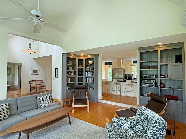 187 Plain Rd, Greenfield, MA 01301 - living room featuring light wood finished floors, high vaulted ceiling, ceiling fan, baseboards, and an AC wall unit