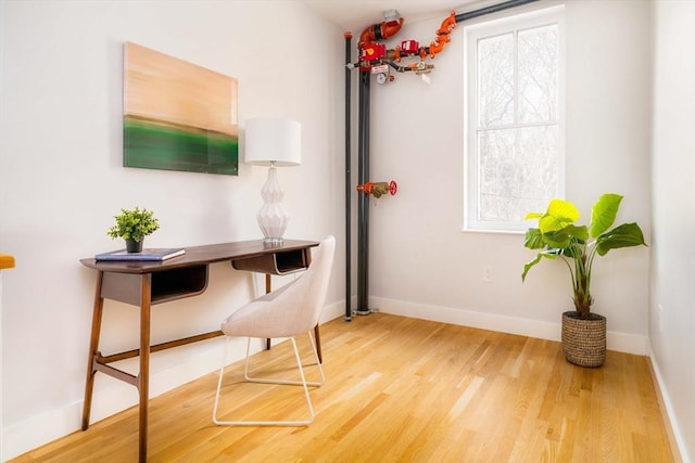 office area with hardwood / wood-style floors and a wealth of natural light