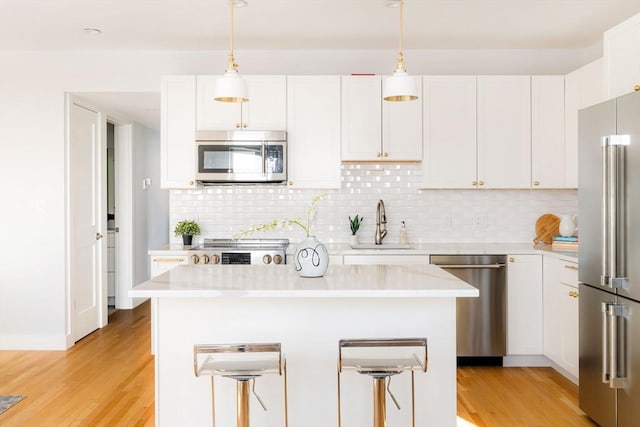 kitchen with stainless steel appliances, white cabinets, and a kitchen island