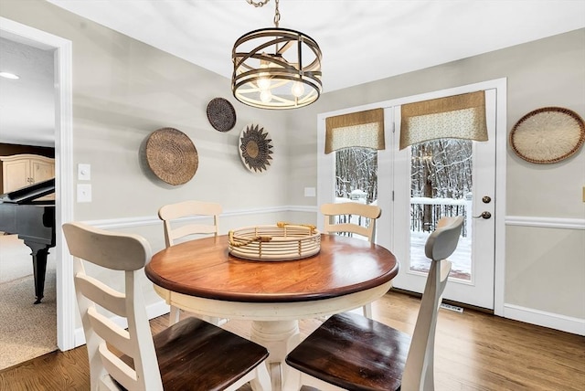 dining space featuring an inviting chandelier and dark wood-type flooring