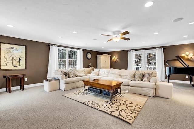 carpeted living room with ceiling fan, french doors, and crown molding