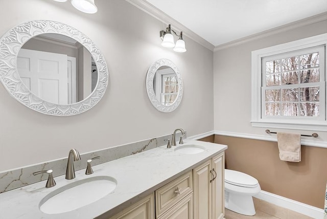 bathroom with tile patterned floors, vanity, crown molding, and toilet