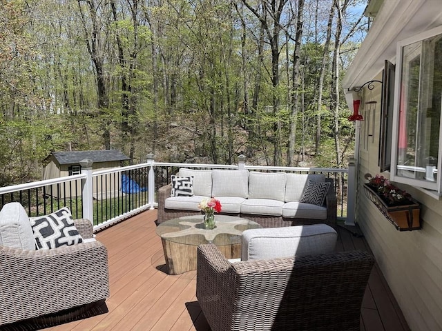 deck with a storage shed and an outdoor living space